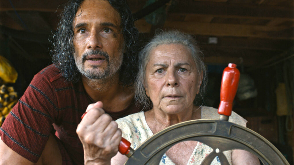 two people with hands on a wheel